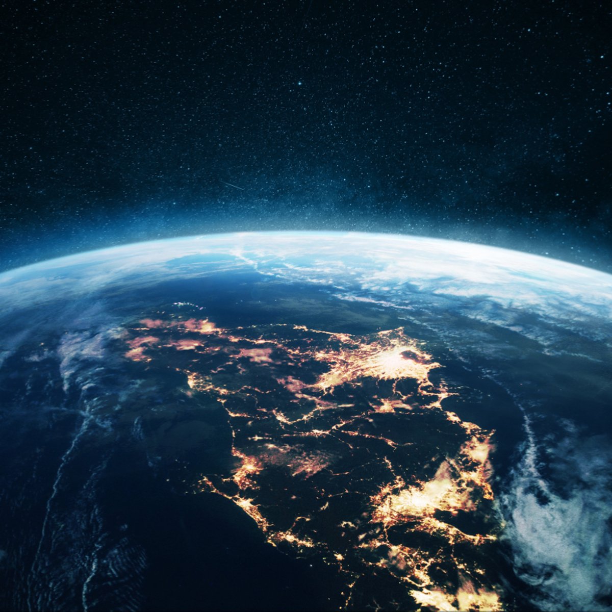 View of Earth from space with glowing city lights, cloud cover, and a star-filled night sky above.