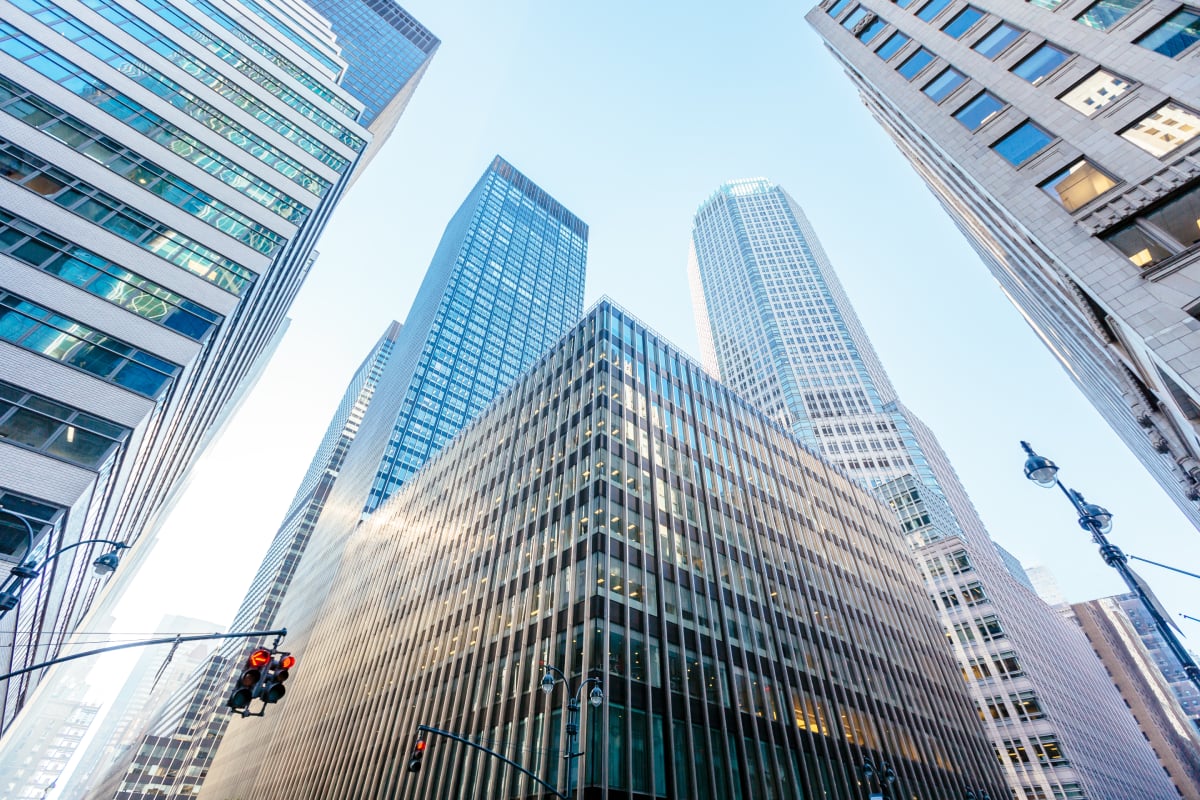 Modern glass and steel skyscrapers viewed from below, illustrating a financial district and corporate environment