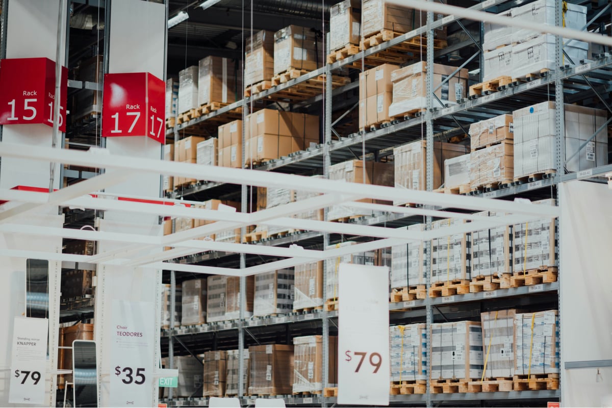  Logistics warehouse with metal shelving and stacked boxes, illustrating storage, supply chain and distribution
