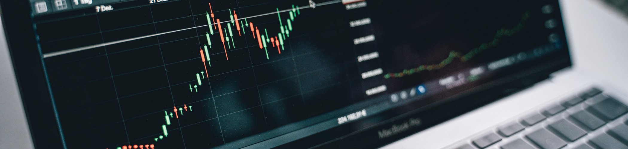 Trading charts displayed on a laptop with candlesticks and indicators, illustrating financial market analysis and investment
