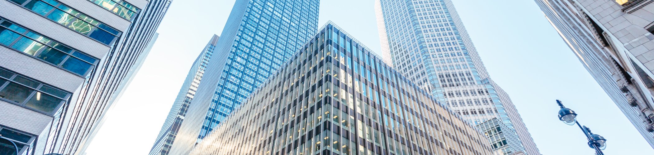 Modern glass and steel skyscrapers viewed from below, illustrating a financial district and corporate environment