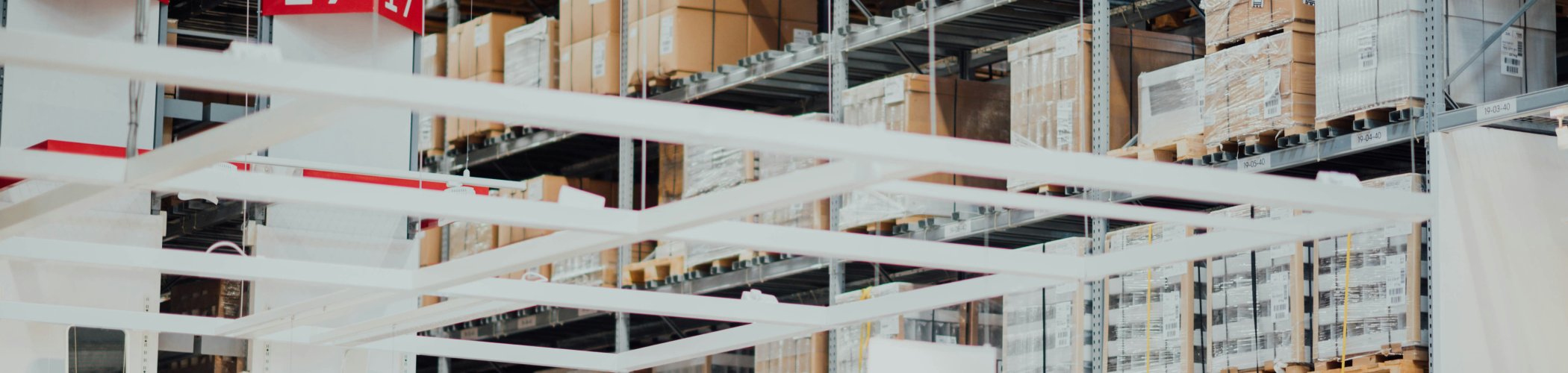  Logistics warehouse with metal shelving and stacked boxes, illustrating storage, supply chain and distribution