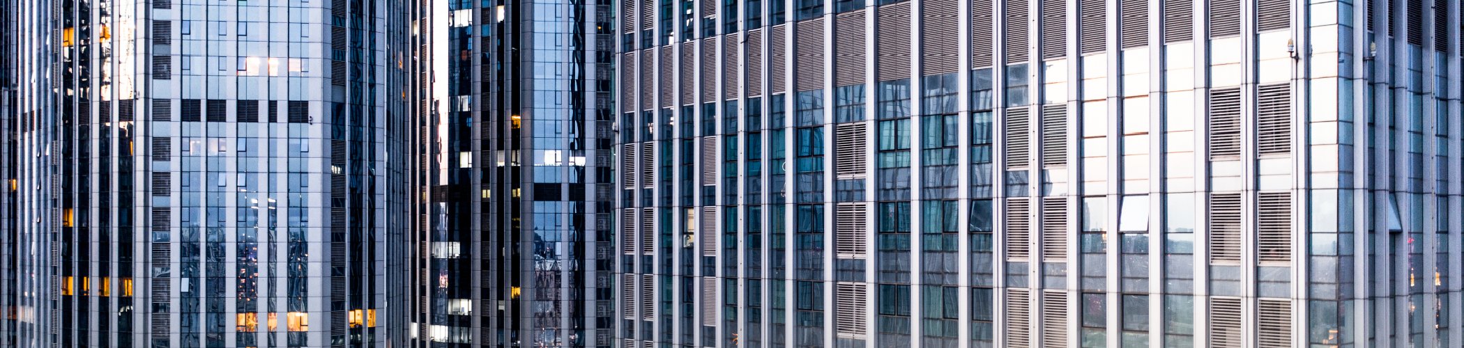 Modern office towers in a major financial district symbolizing corporate growth, investment and economic activity