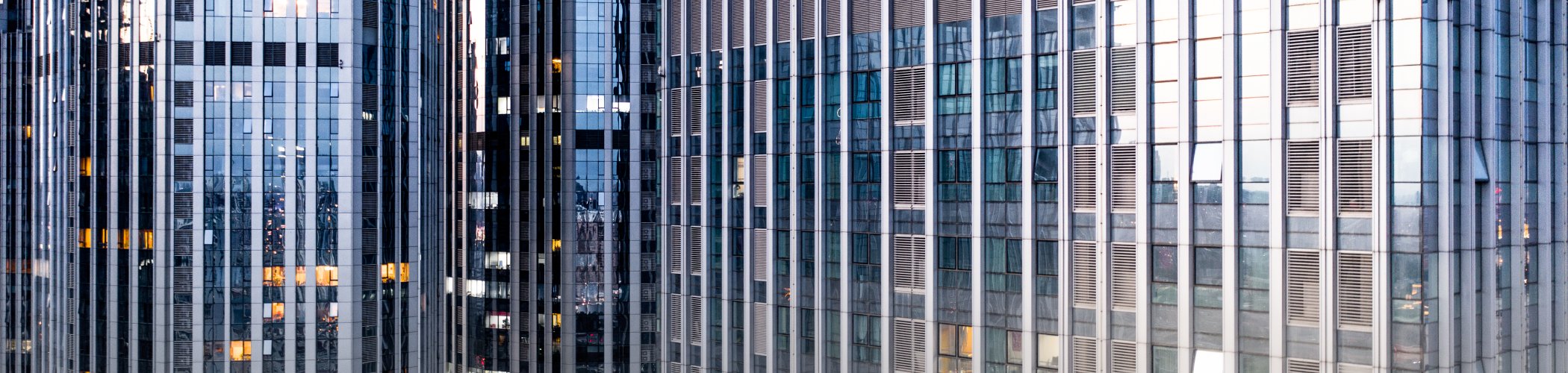 Modern office towers in a major financial district symbolizing corporate growth, investment and economic activity