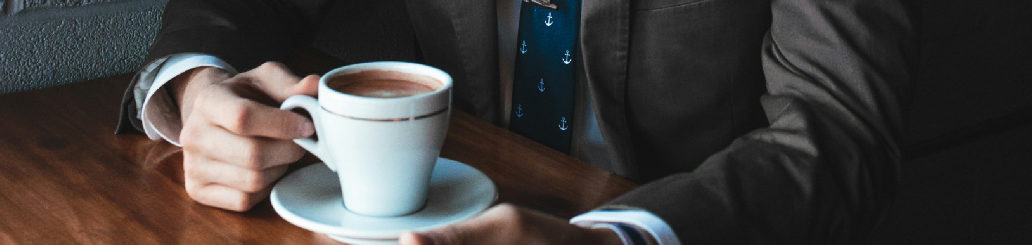Professional reviewing market insights over coffee, illustrating investment analysis and financial strategy