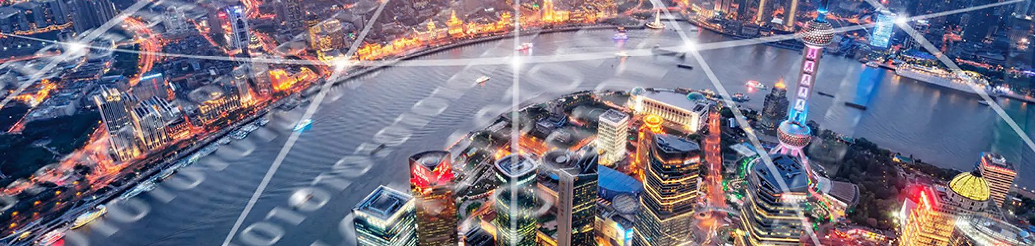 Aerial view of Shanghai at night with a network of digital connections, illustrating digital transformation and a connected economy
