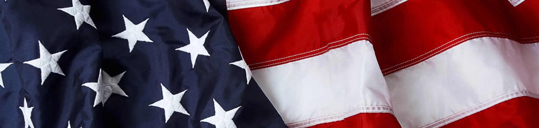 Close-up of the United States flag with stars and stripes, illustrating national identity and the American political context
