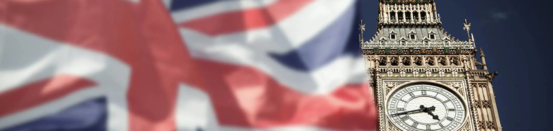 Big Ben tower with a British flag in the background, illustrating the United Kingdom and its political and economic context

