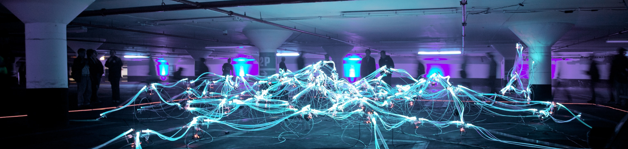Light art installation with cables and fiber optics in an underground parking, illustrating networks, connectivity and data
